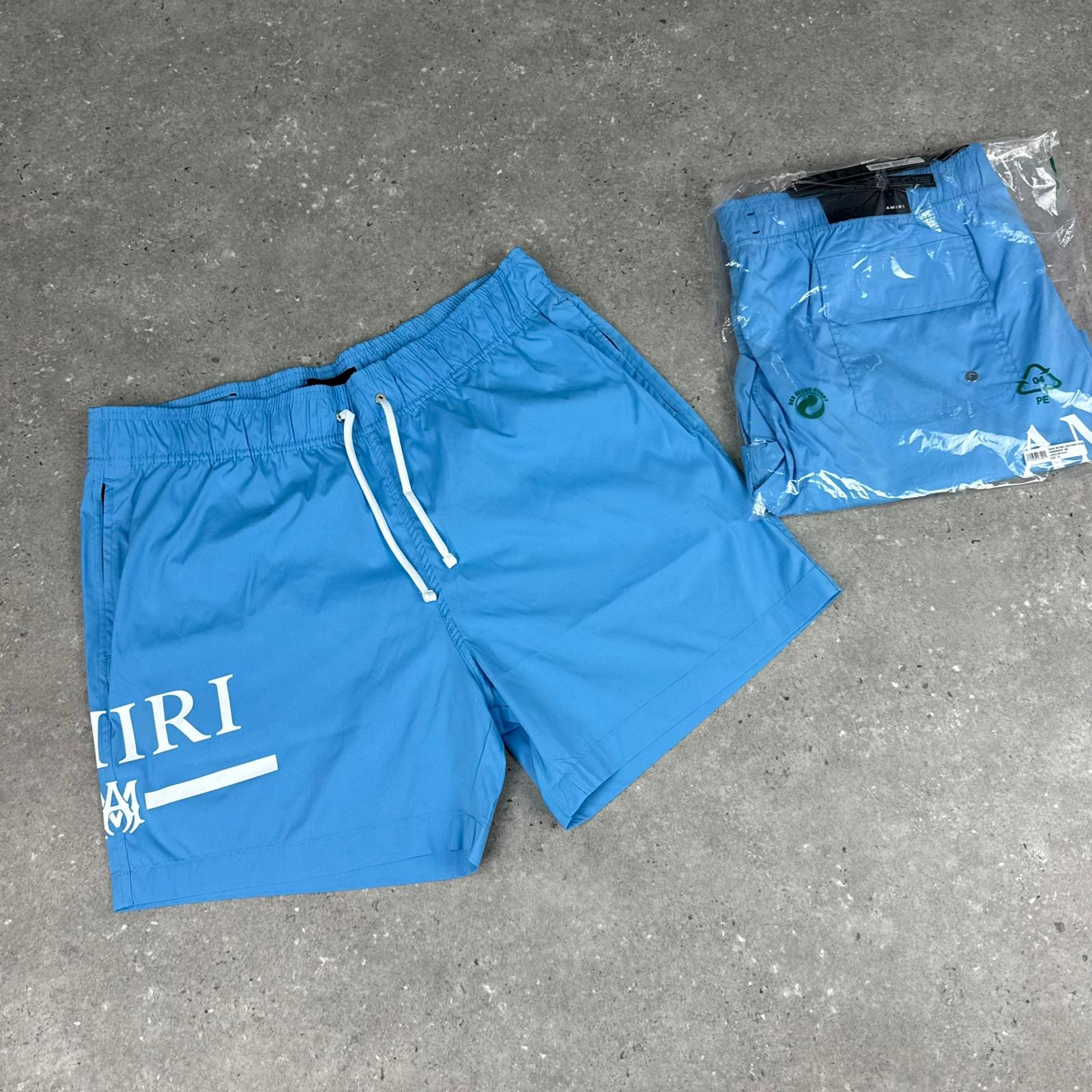 AMIRI- MA Bar logo Swim Shorts
Carolina Blue